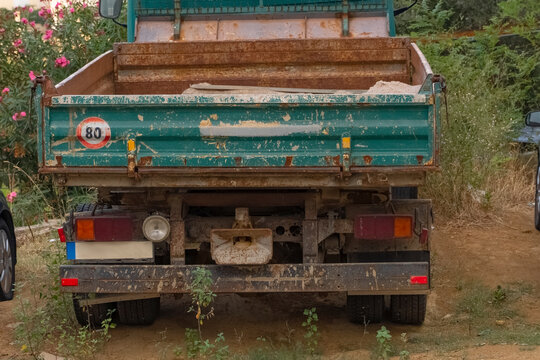 An Old Rusty Truck Abandoned In The Parking Lot. A Truck, Rusted With Moisture And Time, Left By People In A Landfill.