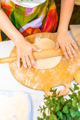 women's hands close-up sculpt pastry from dough and flour home cooking traditional food women's household