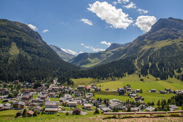 Fototapeta na wymiar View of austrian village Lech am Arlberg at the European Alps with mountain Omeshorn, during summer