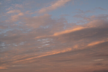 Majestic cloudy sunset at dusk dramatic skyscape. Amazing clouds with orange light of nature