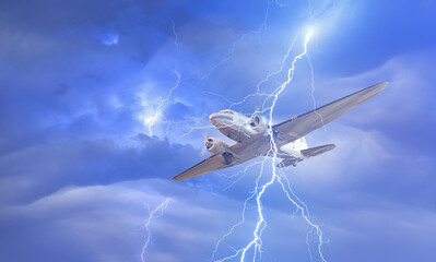 Vintage type old metallic propeller airplane in the sky with lightning