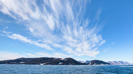 Melting icebergs by the coast of Greenland, on a beautiful summer day - Melting of a iceberg and pouring water into the sea - Greenland