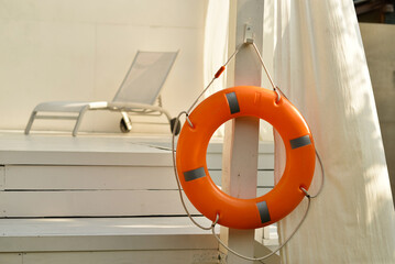 lifebuoy hanging near the pool, the concept of safety during outdoor activities