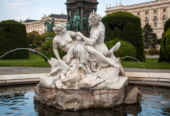 Triton and Mermaid Fountain craved in white marble in Maria Theresa Square in the old town of Vienna, Austria, Central Europe.
