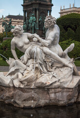 Triton and Mermaid Fountain craved in white marble in Maria Theresa Square in the old town of Vienna, Austria, Central Europe.