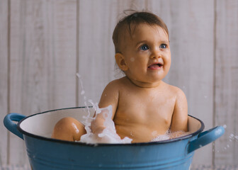 Baby splash water while bath in milk