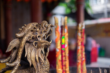 chinese dragon sculpture near incense container