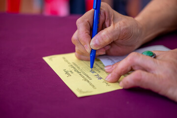 Hand writing a note for donation