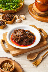 Rendang Pork or Rendang babi. 

Rendang babi is often described as a rich dish of meat  that has been slow cooked and braised in a coconut milk seasoned with a herb and spice mixture.