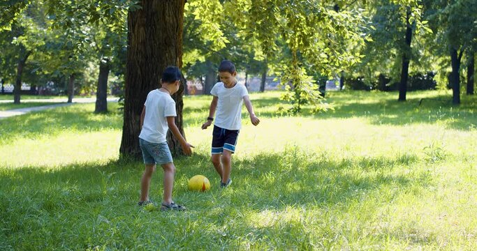 4k video of a boys playing ball outdoor.