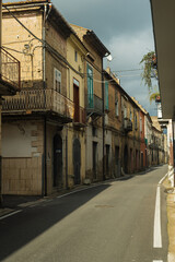 Small old street in the south of Italy. Shabby stone houses.