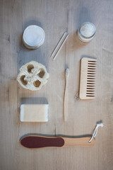 Top view eco-friendly bath accessories: sponges. toothpaste, soap on a wooden background. High quality 