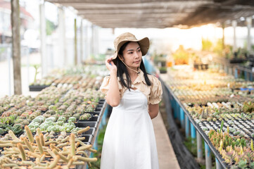 Portrait of Young Asian woman SME small business entrepreneur as cactus plant farm owner smile