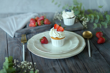 Vanilla cupcake with fruits, on a wooden table background, top view, copy space. Seasonal, morning Sunday breakfast and rest.

