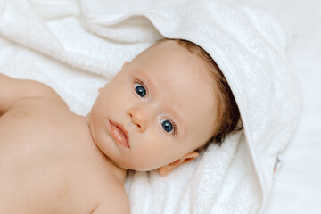 Portrait of a baby, Happy smiling baby in a towel after bathing	