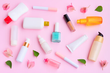 Decorative cosmetics set with pink bougainvillea flowers on pink background