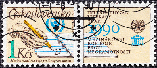 CZECHOSLOVAKIA -CIRCA 1990: A stamp printed in Czechoslovakia shows UNESCO World Literacy Year, serie. - obrazy, fototapety, plakaty