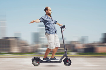 Man riding an electric scooter hands free