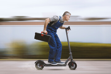 Professional repairman riding an electric scooter © stokkete