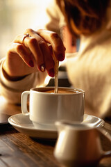 Beautiful girl enjoying cup of coffee. Woman with the cup of beverage.