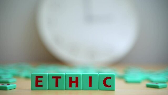 The word ETHICS made of small colorful cubes and many scrambled letters laying around on the table. Core Values. Integrity Ethics Principals And Accountability. High quality 4k footage