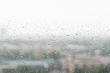 Rain droplets on window with out of focus background