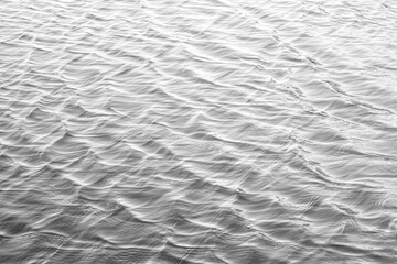 Water surface with ripples and sunlight reflections