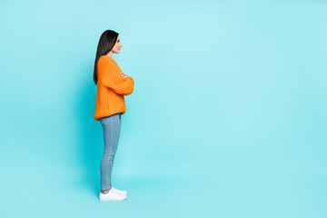 Fototapeta na wymiar Full size profile photo of charming positive lady crossed arms look empty space isolated on teal color background