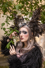 Portrait of a beautiful mysterious woman in the image of a dark elf queen.
