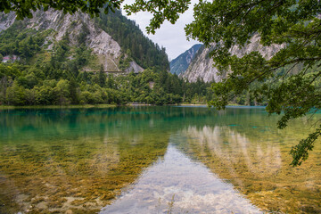 Beautiful view of the Five Flower Lake (Multicolored Lake) with azure water among fall woods in...