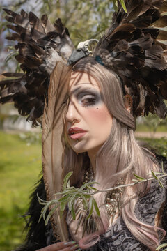Close-up portrait of a fantasy woman in a costume with feathers
