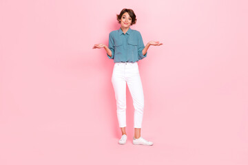 Photo of funny pretty lady wear stylish trendy clothes open arm palm no answer stand empty space isolated on pink color background