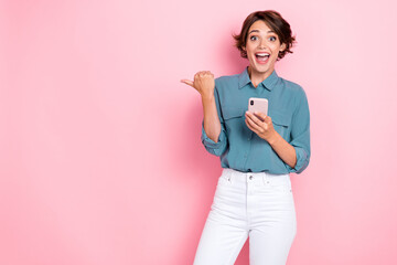 Photo of impressed girl brown hair blue blouse directing empty space instagram telegram facebook twitter isolated on pink color background - obrazy, fototapety, plakaty