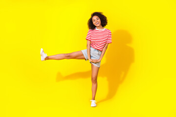 Fototapeta na wymiar Full size photo of young cute sport lady showing gymnastic leg up isolated on bright yellow color background