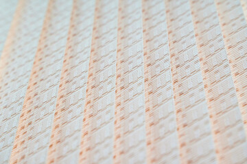 Beige background consisting of vertical lines at shallow depth of field.