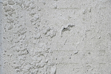 Obraz premium Grey background of concrete plaster, uneven rough surface.