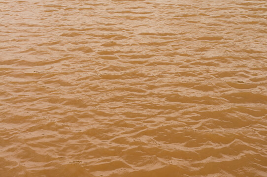 Background lake surface ferrous brown water from coal mining pit water