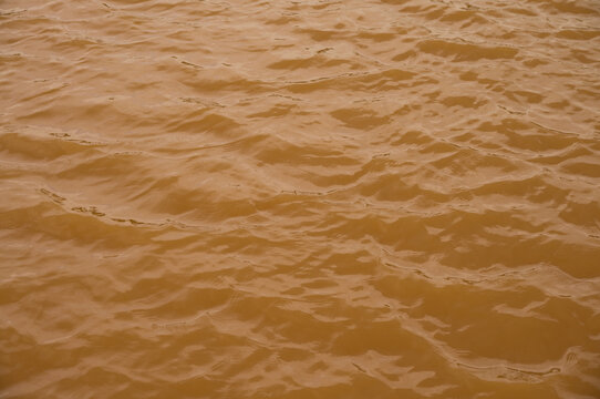 Background lake surface ferrous brown water from coal mining pit water