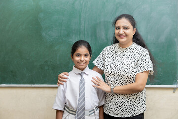 Portrait of Brilliant indian  student girl appreciated by school teacher in classroom., Intelligent, knowledge, Study. 