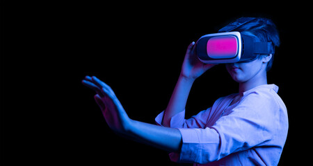 Young indian woman wearing virtual reality goggles headset, asian female have fun with vr box in the dark with colorful blue light, technology and met averse concept. copy space