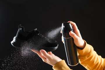 A woman applies a spray from a cylinder with a water-repellent liquid to children's crumbs. Care...