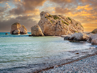 Cyprus sunset. Petra tou Romiou beach. Bay Aphrodite on sunset background. Mediterranean sea shore....