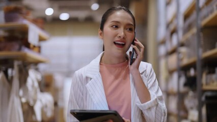 smart business owner asian female startup entrepreneur small business manager businesswoman wear smart casual cloth smile hand use tablet smartphone working inventory checking in showroom studio