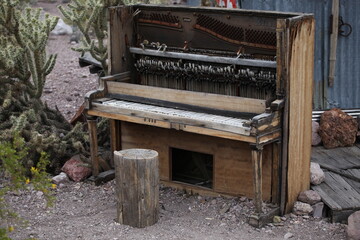 old piano deserted in the desert