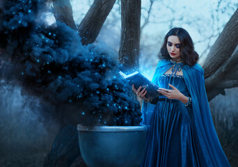 Halloween concept fantasy woman witch conjures, holds book in hands reads spell black magic smoke...