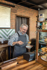 Cheerful cafe worker employee serving a customer