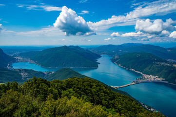 Panoramic view of Lake Lugano and the dam bridge. - obrazy, fototapety, plakaty