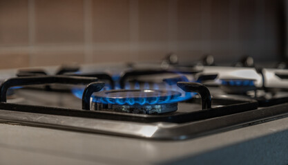 Gas cooker burners in close-up, gas stove, burning gas flames