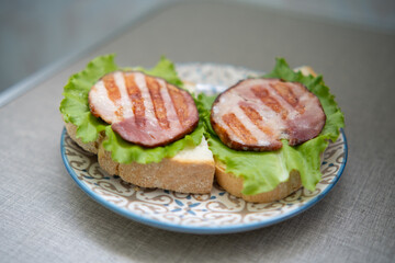 Sandwiches with sausage and fresh green salad leaves