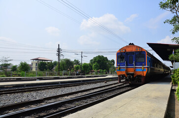 Local bogie locomotive train on track railway stop waiting for send receive thai people and foreign travelers passengers journey go to destination at phra nakhon si ayutthaya city in Bangkok, Thailand